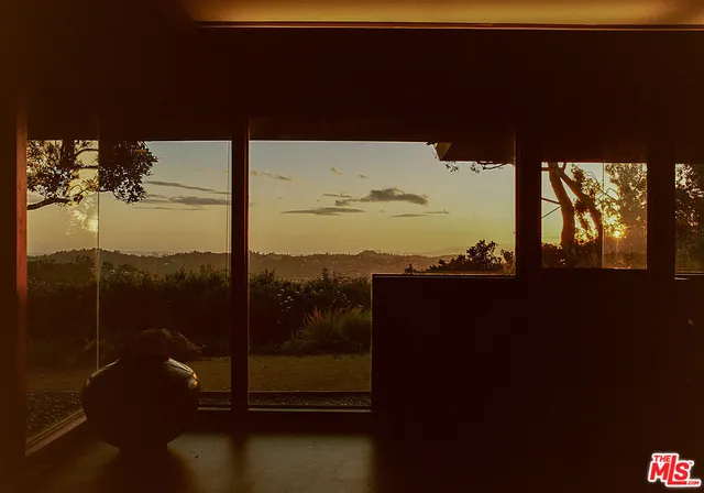 a living room with furniture and a floor to ceiling window