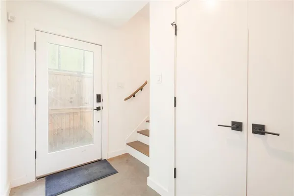 a view of a kitchen with wooden floor and windows