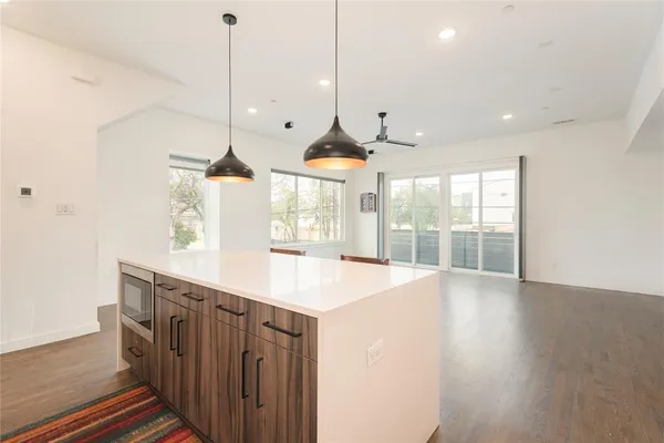 a kitchen with stainless steel appliances granite countertop a sink stove and cabinets