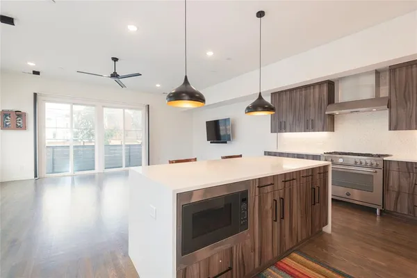 a kitchen with stainless steel appliances a stove a sink and a microwave