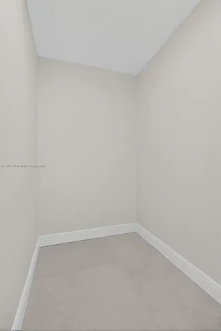 a view of a lake with a yard and large trees