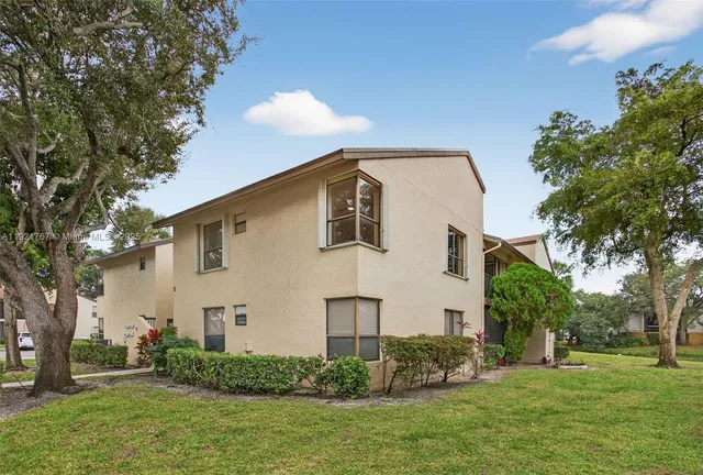 an aerial view of residential houses with city and green space