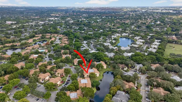 an aerial view of a house with a yard and lake view