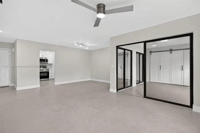 a view of an empty room with a kitchen