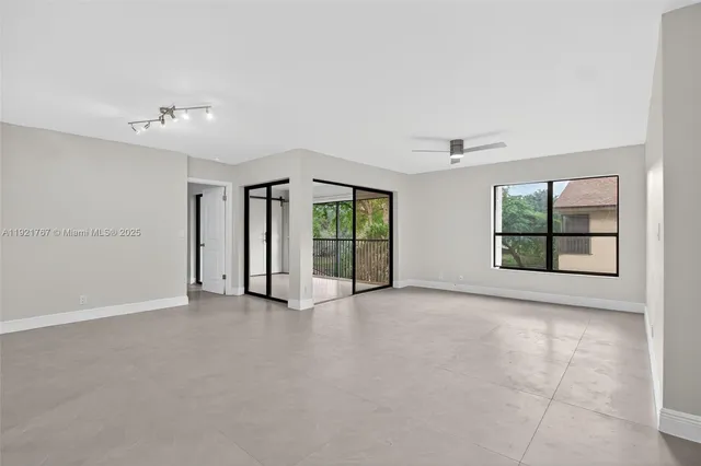 an empty room with windows and closet