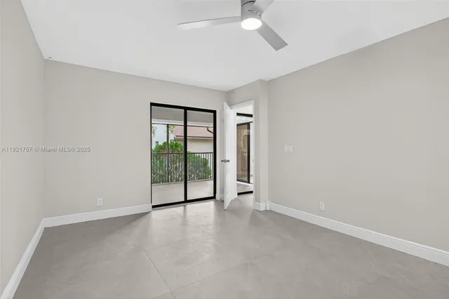 an empty room with windows and city view