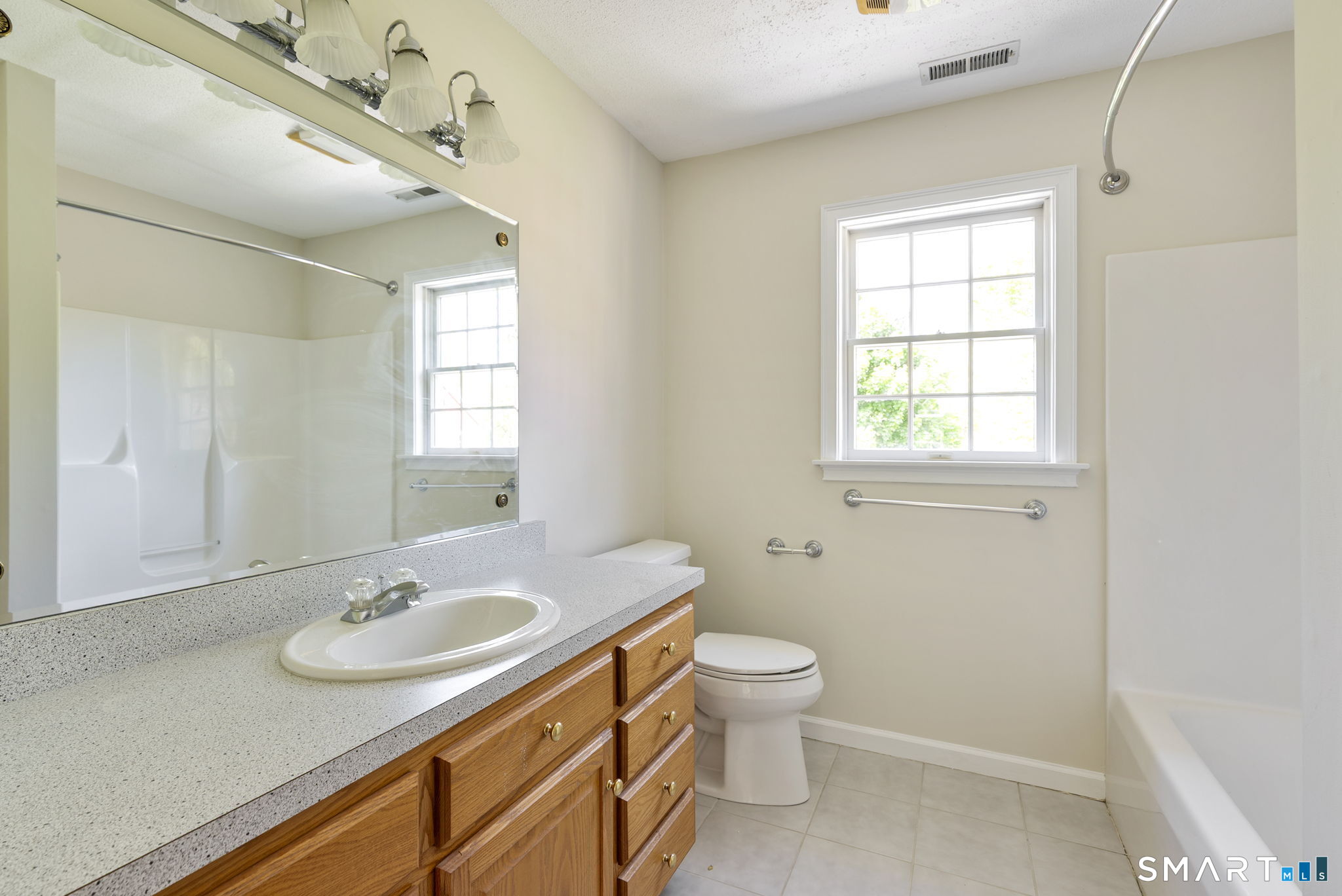 555 Waterville Road Avon, CT 06001 - Photo 34 of 40 a bathroom with 2 sink toilet and a mirror