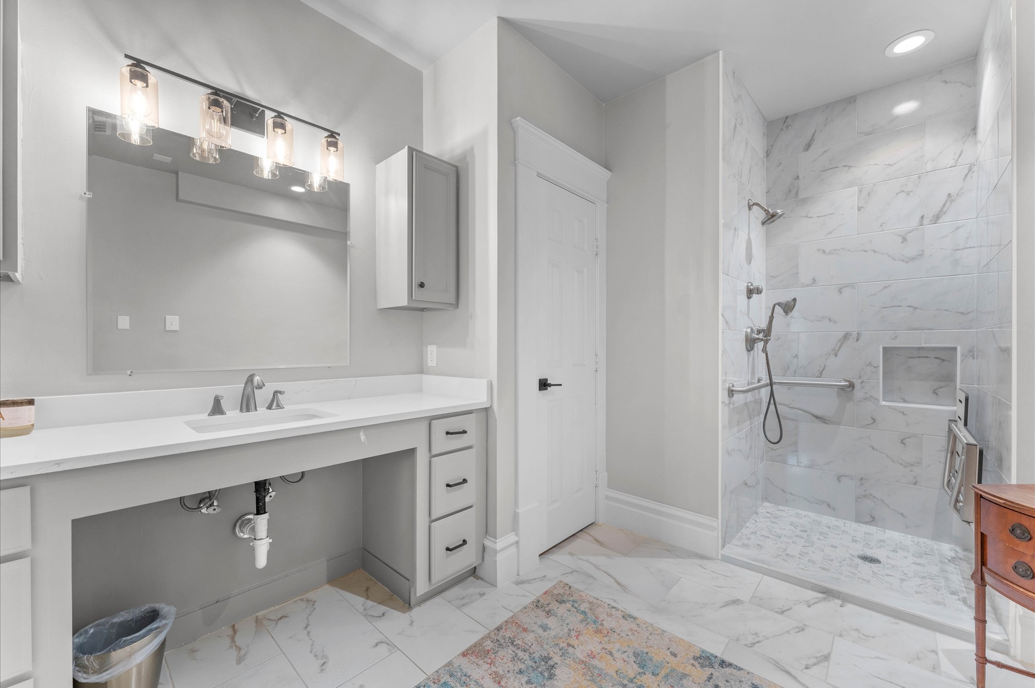 945 Harvard Street Houston, TX 77008 - Photo 31 of 47 a bathroom with a shower sink and mirror