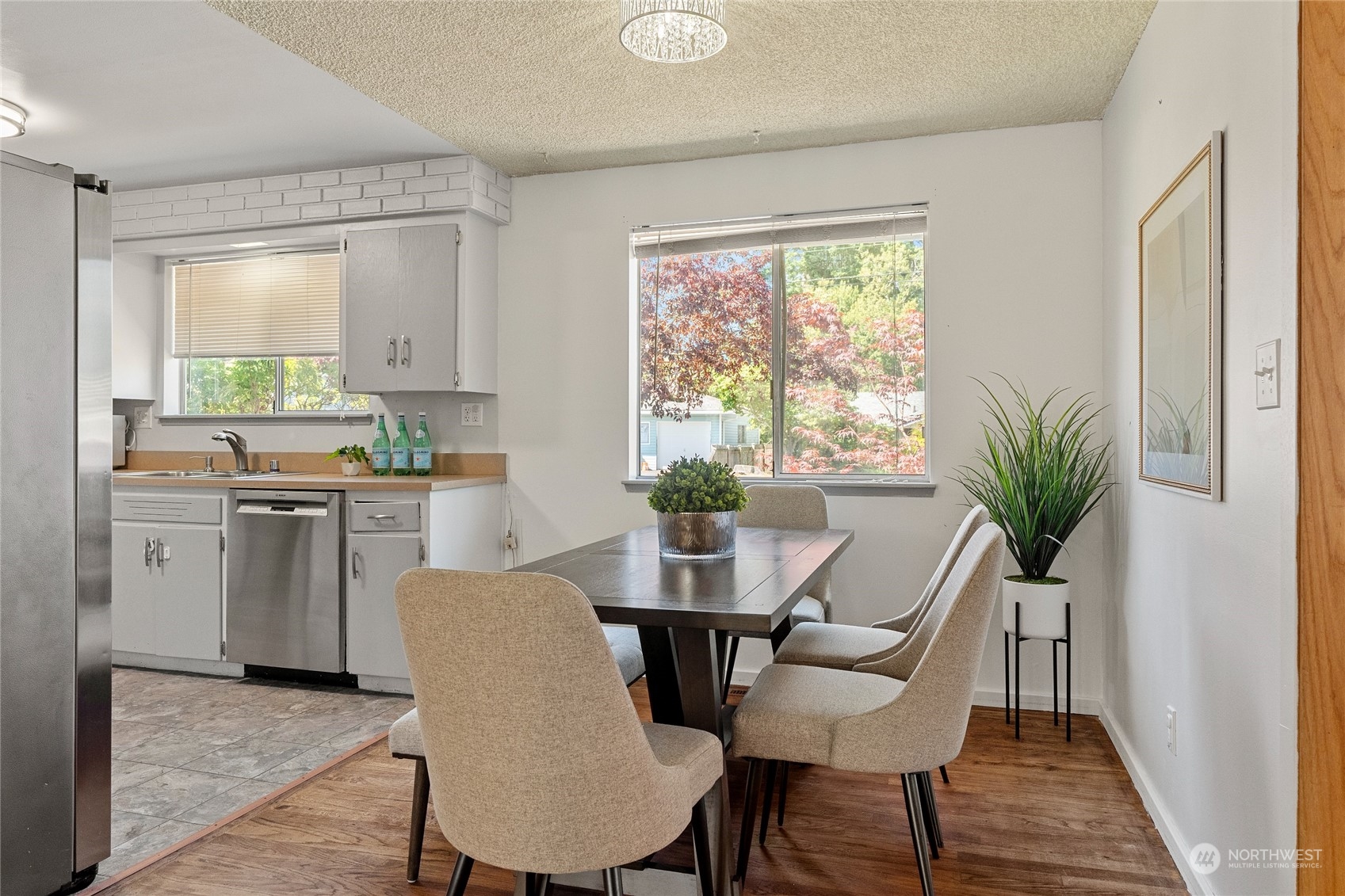 7623 Tyee Road Everett, WA 98203 - Photo 14 of 37 a view of a dining room with furniture window and wooden floor