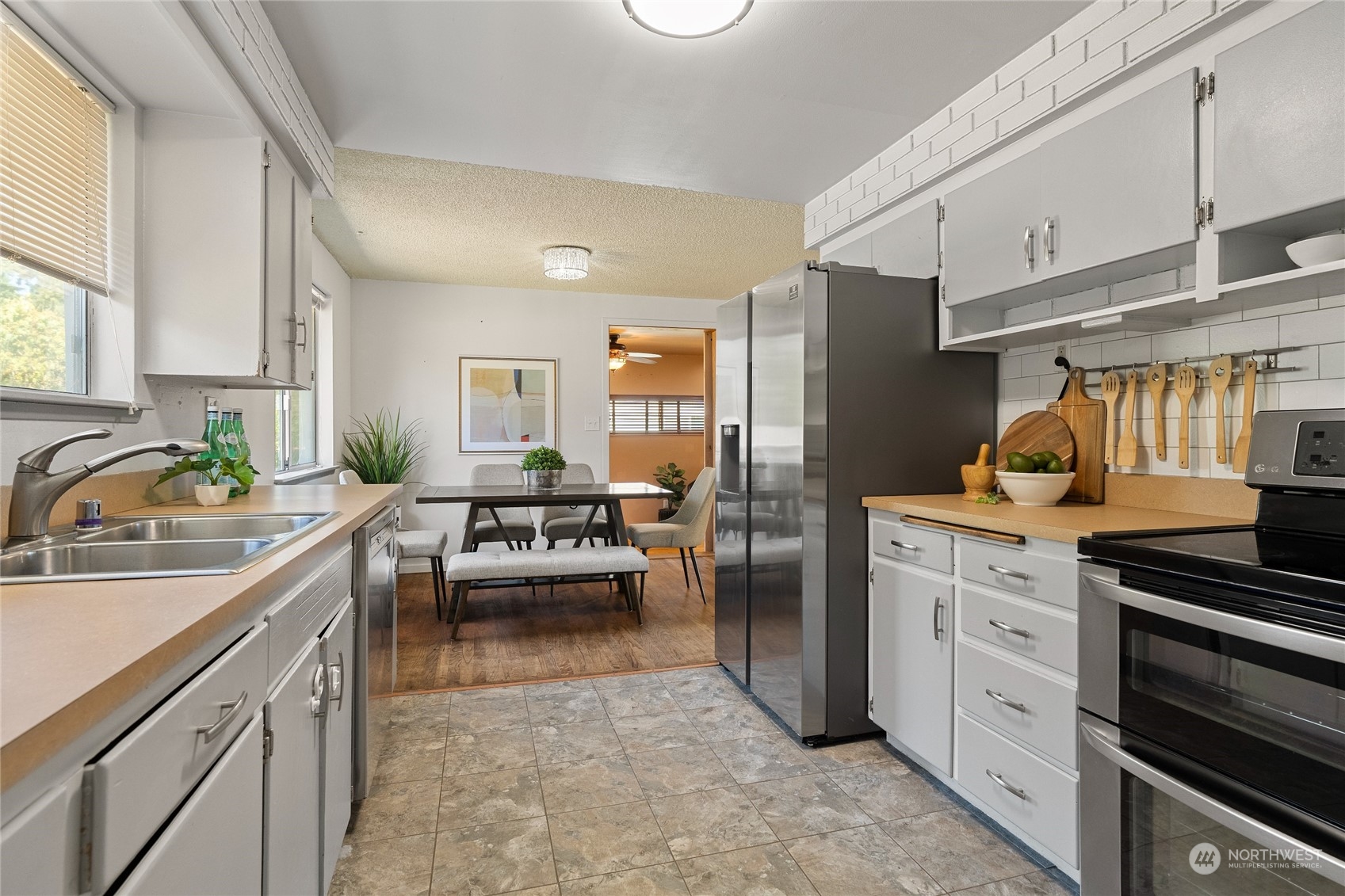 7623 Tyee Road Everett, WA 98203 - Photo 18 of 37 a kitchen with a sink dishwasher stove and refrigerator