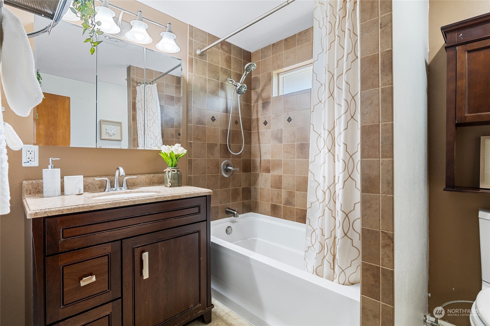 7623 Tyee Road Everett, WA 98203 - Photo 27 of 37 a bathroom with a granite countertop sink a toilet a bathtub and shower