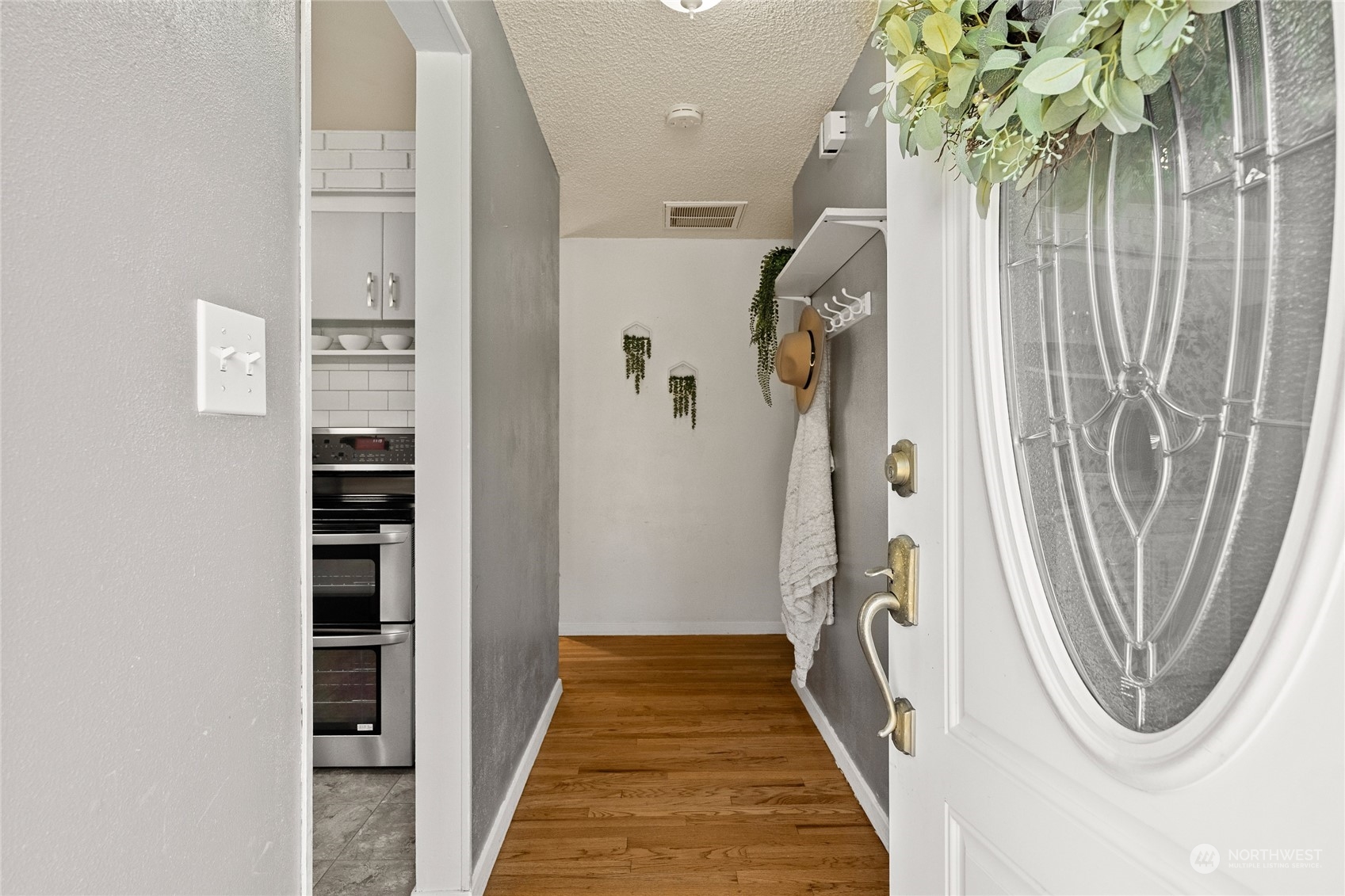 7623 Tyee Road Everett, WA 98203 - Photo 3 of 37 a view of a hallway with wooden floor and entryway