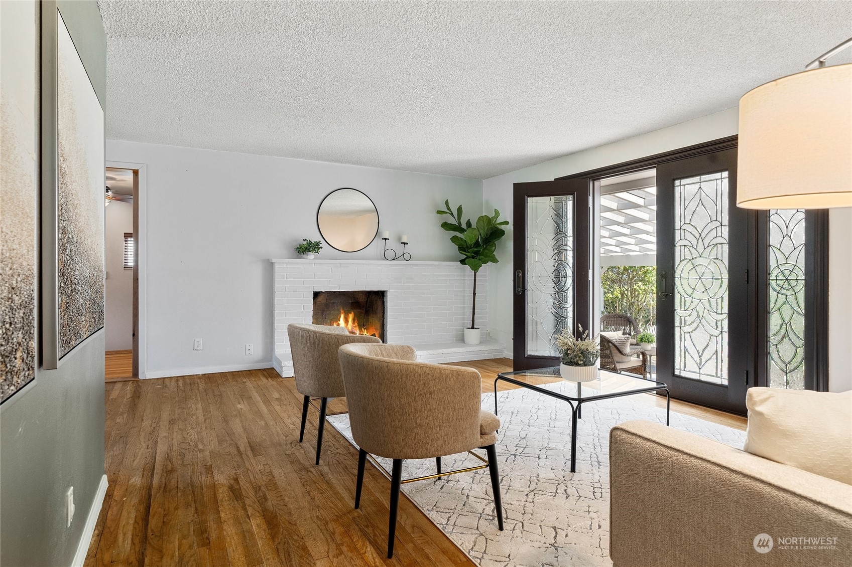 7623 Tyee Road Everett, WA 98203 - Photo 8 of 37 a living room with furniture a large window and a fireplace
