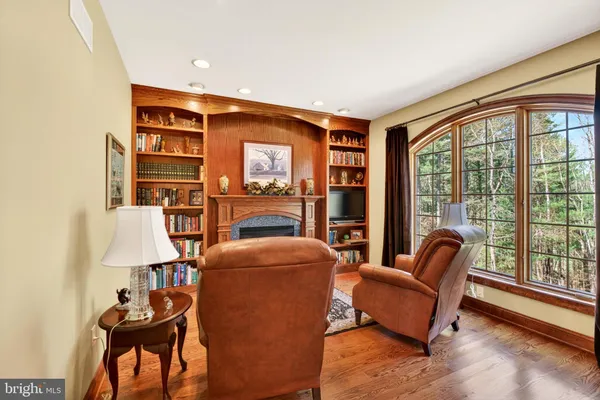 a kitchen with stainless steel appliances granite countertop a refrigerator a stove top oven a sink dishwasher and wooden cabinets with wooden floor