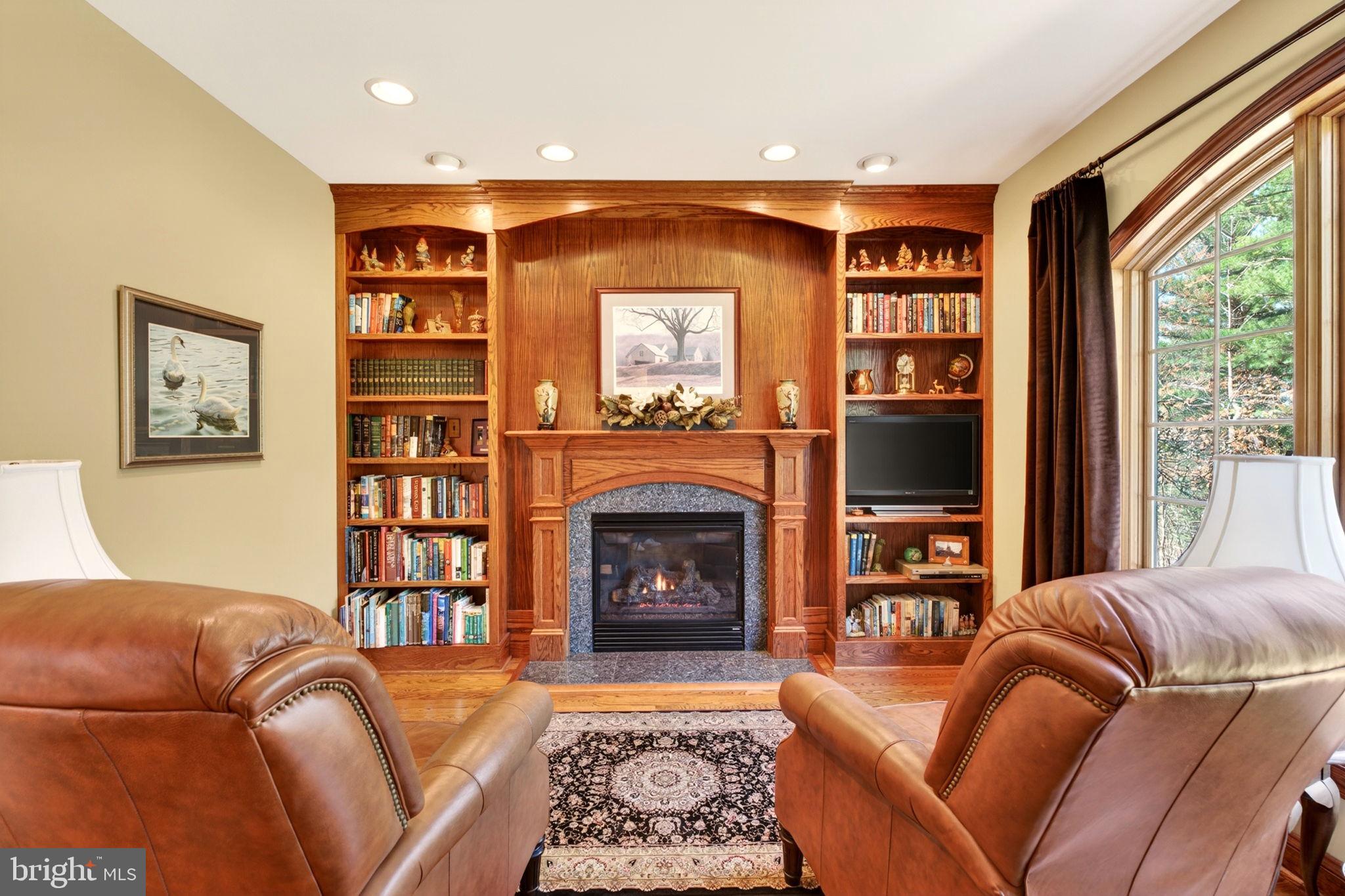 3814 Rocks Station Road Street, MD 21154 - Photo 18 of 70 a living room with furniture a bookshelf and a fireplace