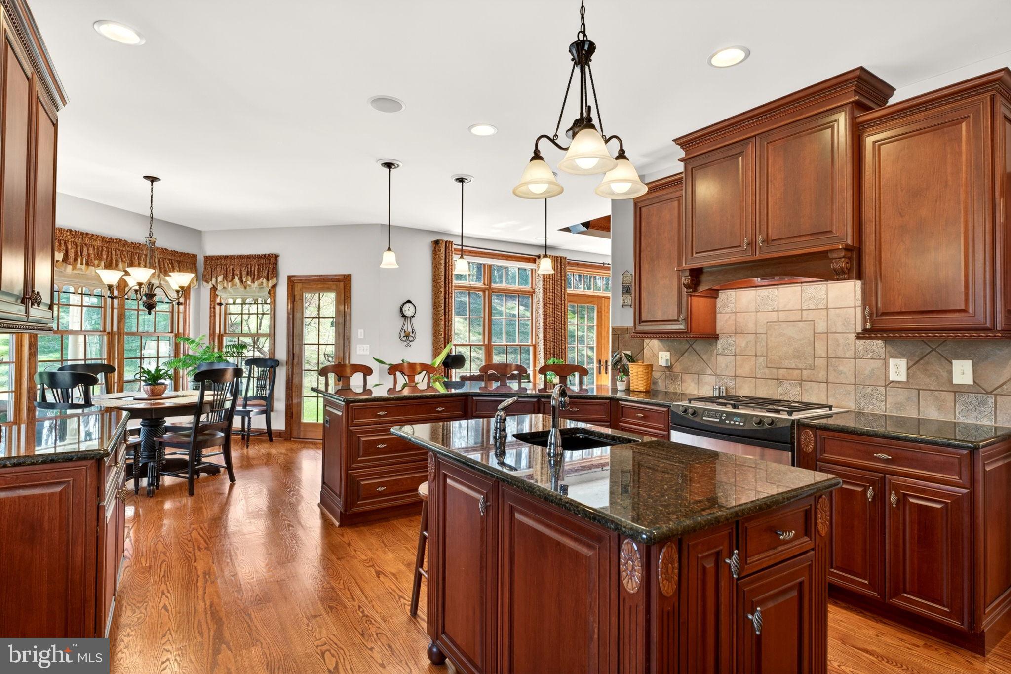 3814 Rocks Station Road Street, MD 21154 - Photo 29 of 70 a kitchen with stainless steel appliances granite countertop a sink a stove and a wooden floors