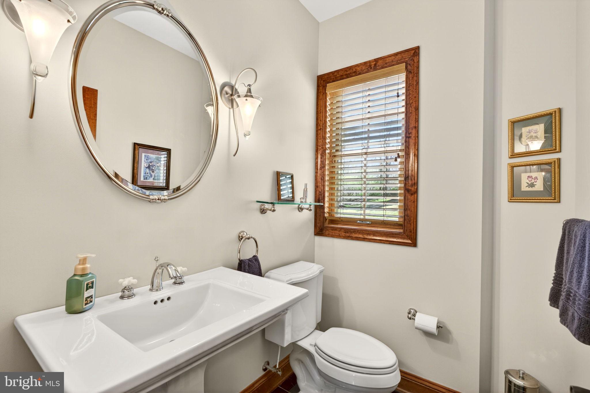 3814 Rocks Station Road Street, MD 21154 - Photo 36 of 70 a bathroom with a sink a mirror a toilet and a window