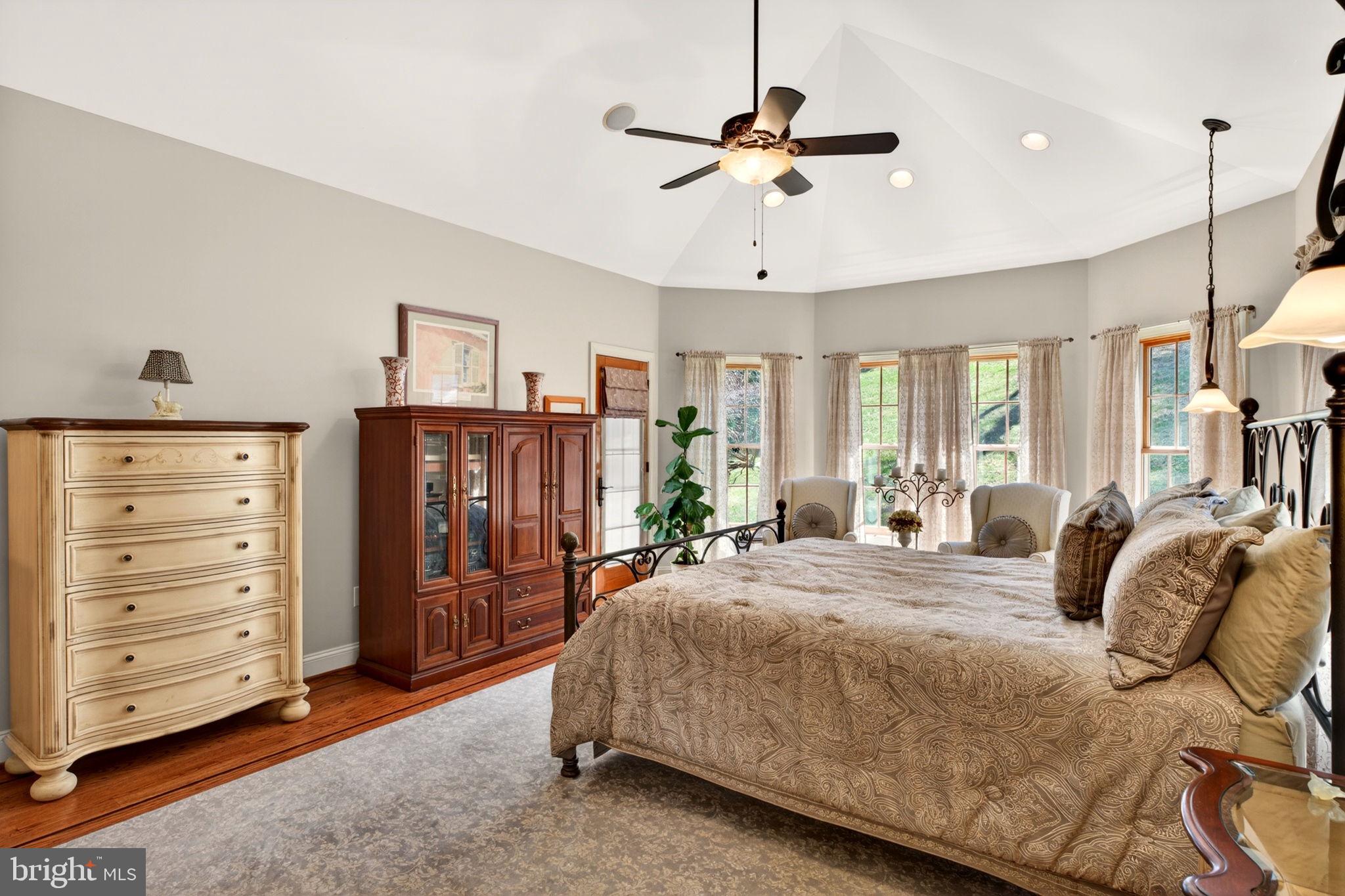 3814 Rocks Station Road Street, MD 21154 - Photo 39 of 70 a bedroom with a bed a dresser and a chandelier
