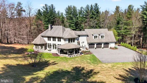 front view of a house with a yard and sitting area