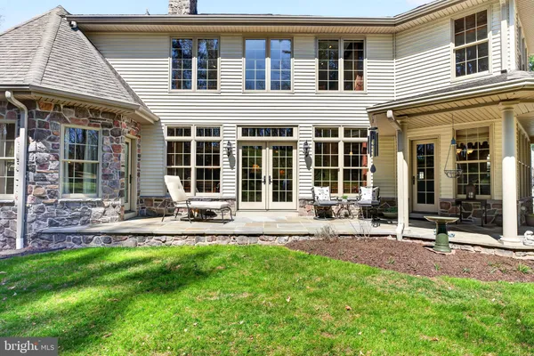 a front view of a house with garden and sitting area