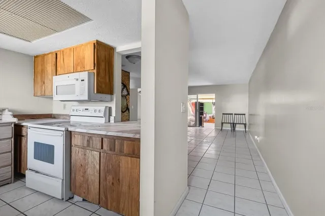 a view of a kitchen with microwave and cabinets