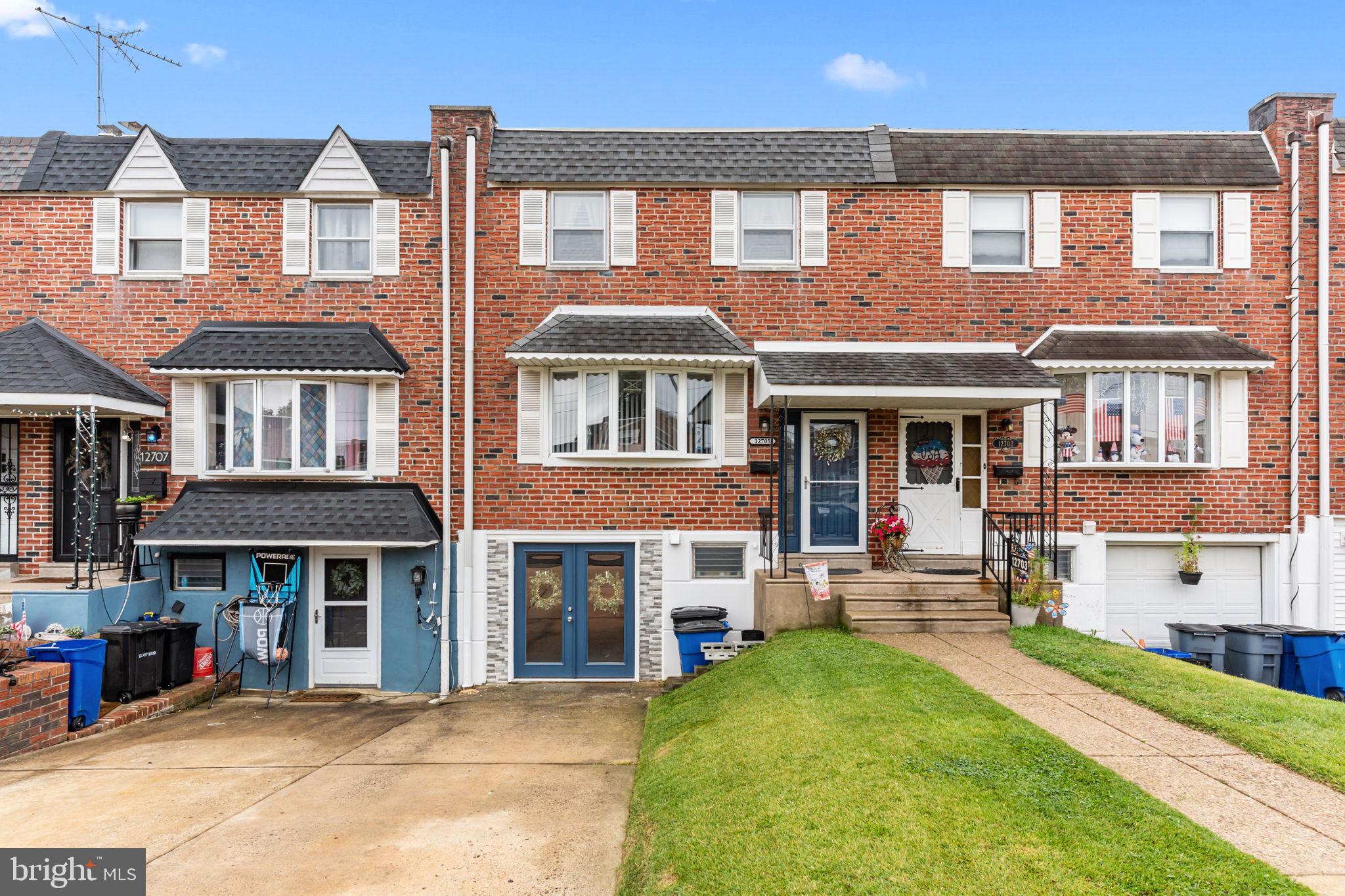12705 Medford Road Philadelphia, PA 19154 - Photo 1 of 29 a front view of a residential apartment building with a yard