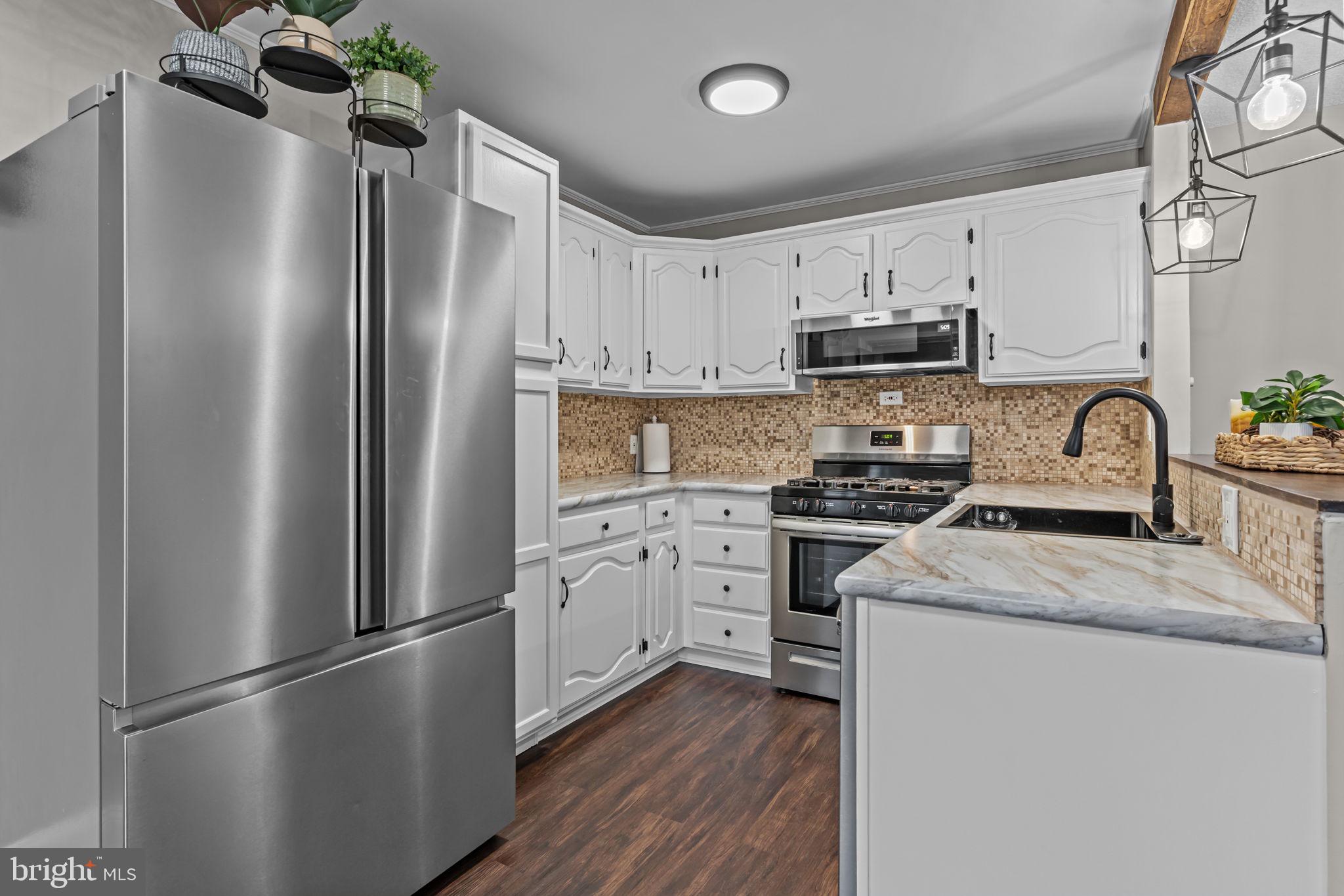 12705 Medford Road Philadelphia, PA 19154 - Photo 11 of 29 a kitchen with stainless steel appliances a refrigerator sink and microwave