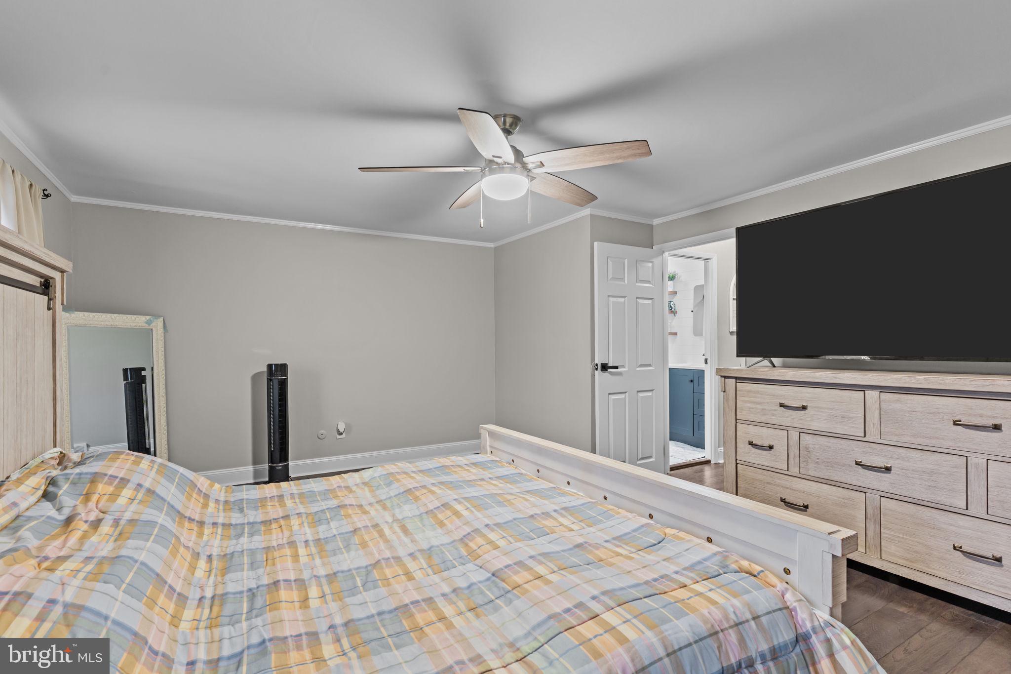 12705 Medford Road Philadelphia, PA 19154 - Photo 16 of 29 a bedroom with a bed and a flat screen tv in white walls