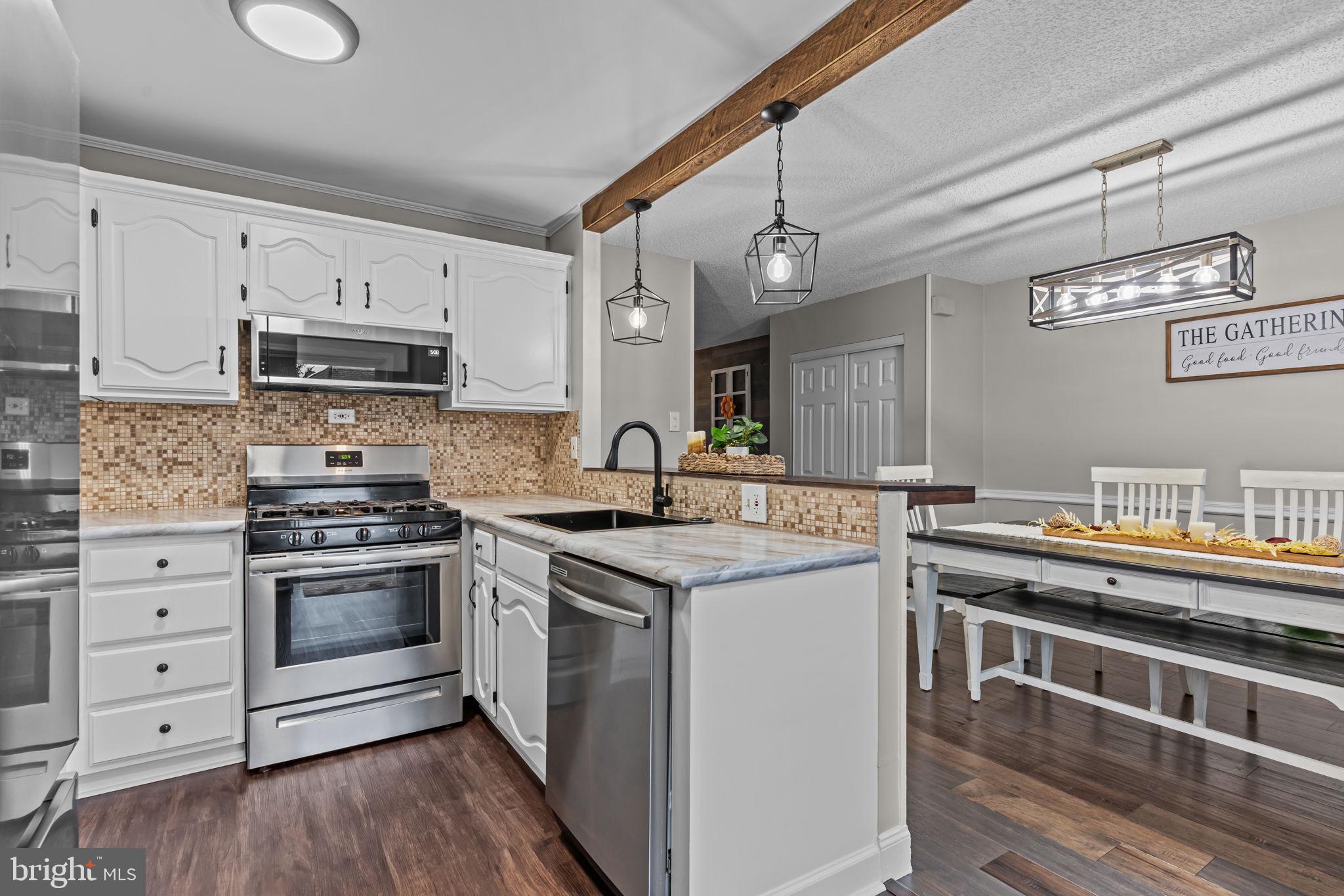12705 Medford Road Philadelphia, PA 19154 - Photo 9 of 29 a kitchen with stainless steel appliances granite countertop a stove and a sink