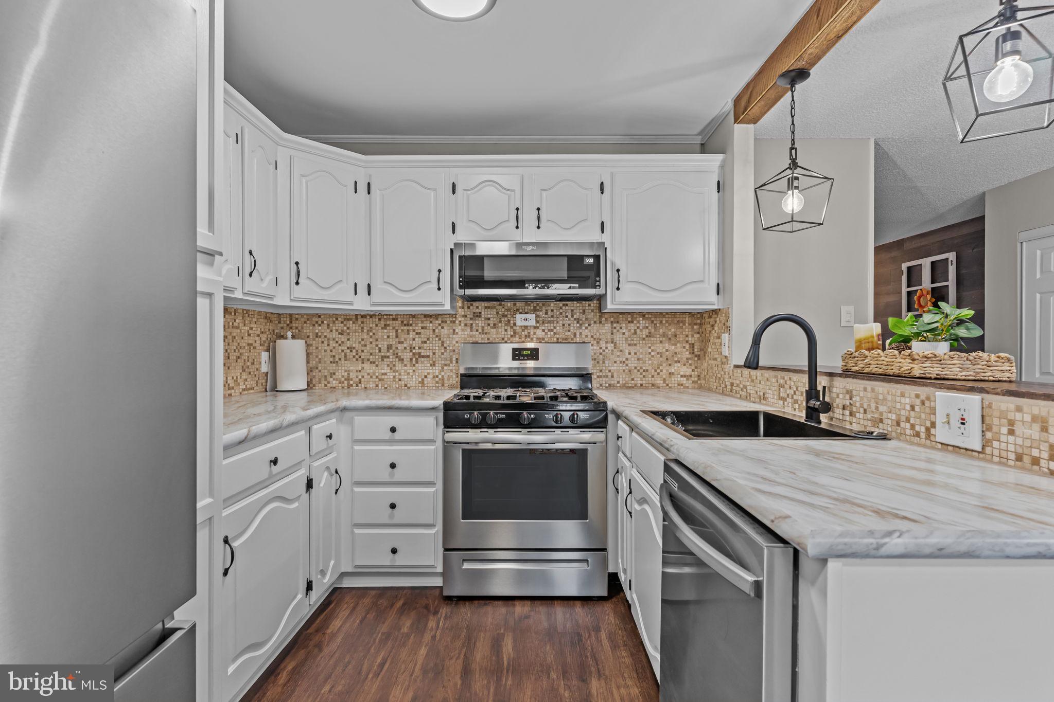12705 Medford Road Philadelphia, PA 19154 - Photo 10 of 29 a kitchen with stainless steel appliances granite countertop a stove and a sink
