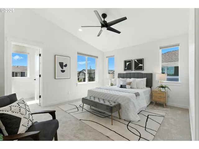 a spacious bedroom with a bed a couch and a chandelier