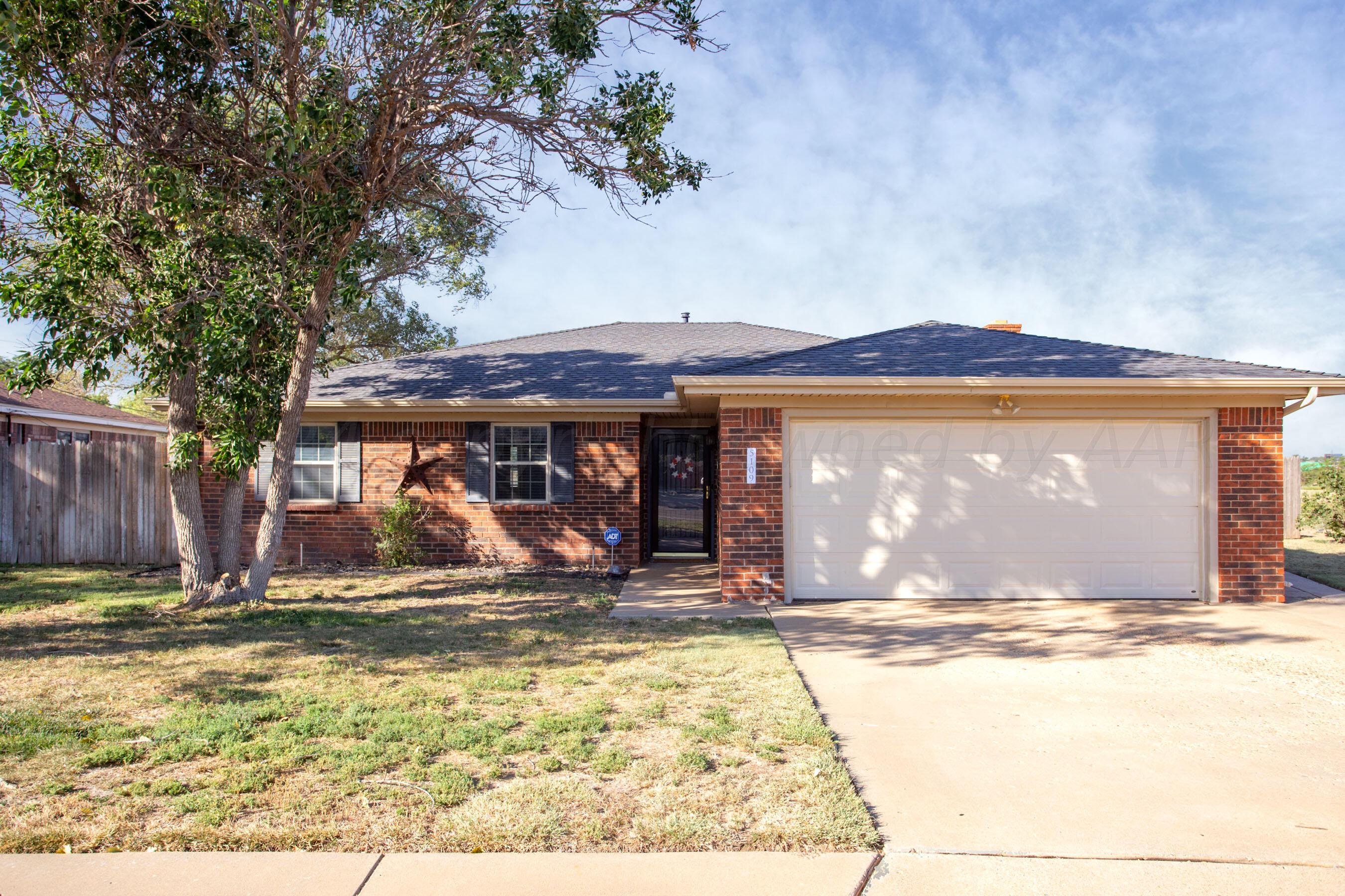 a view of a house with yard and sitting area