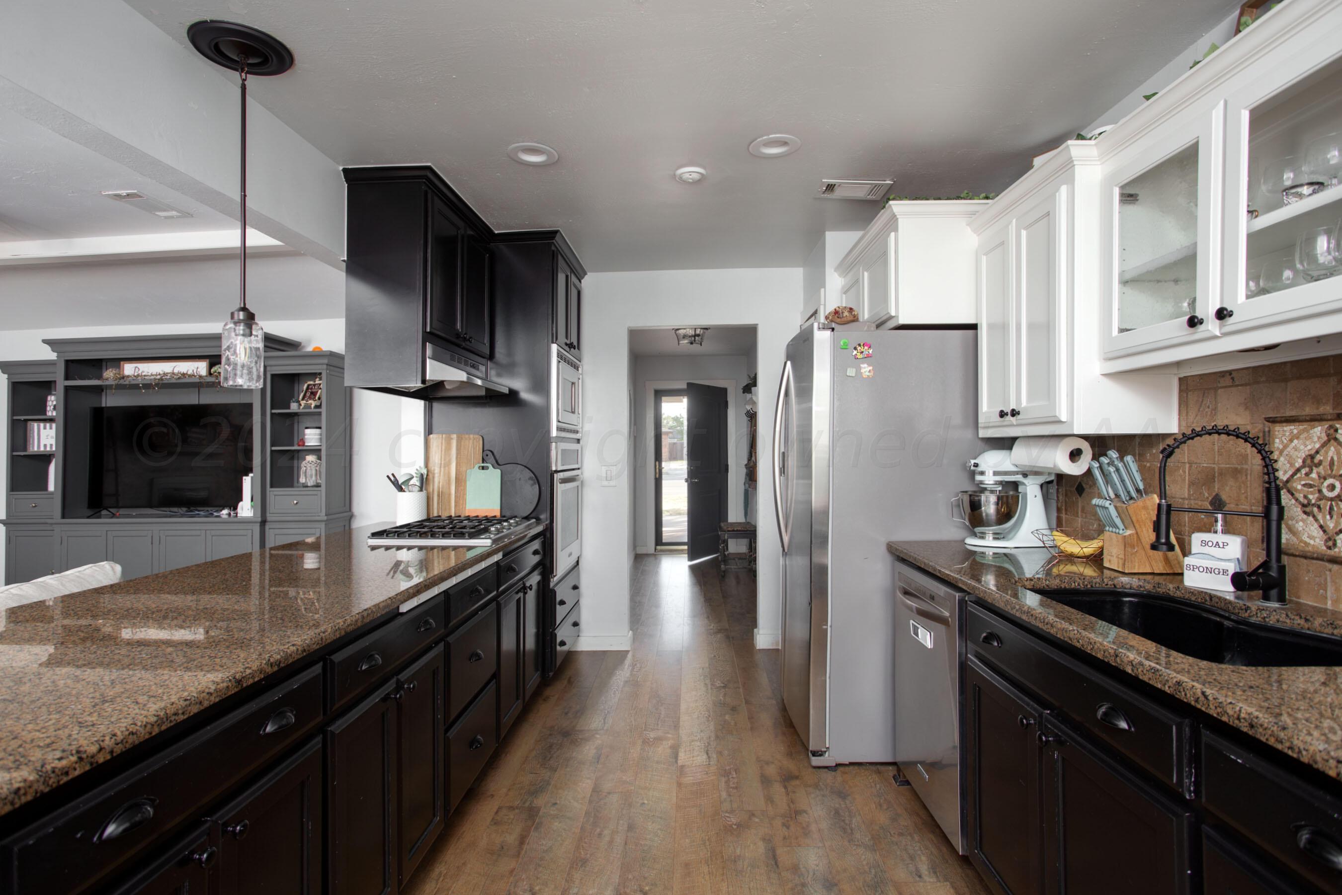 5109 Navajo Trail Amarillo, TX 79110 - Photo 11 of 29 a kitchen with stainless steel appliances granite countertop a sink refrigerator and cabinets