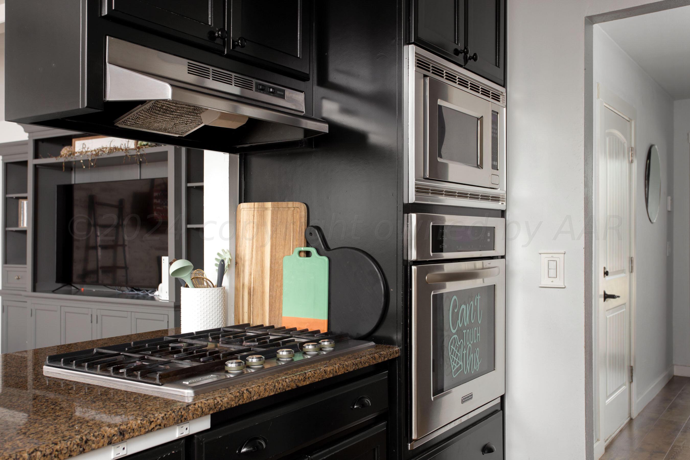 5109 Navajo Trail Amarillo, TX 79110 - Photo 12 of 29 a kitchen with stainless steel appliances granite countertop a stove and a refrigerator