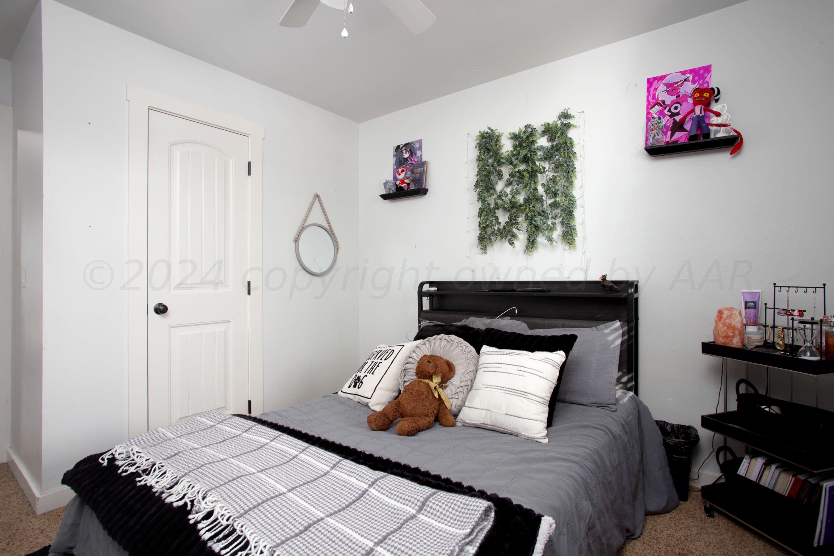 5109 Navajo Trail Amarillo, TX 79110 - Photo 16 of 29 a bedroom with a bed and a dresser in it
