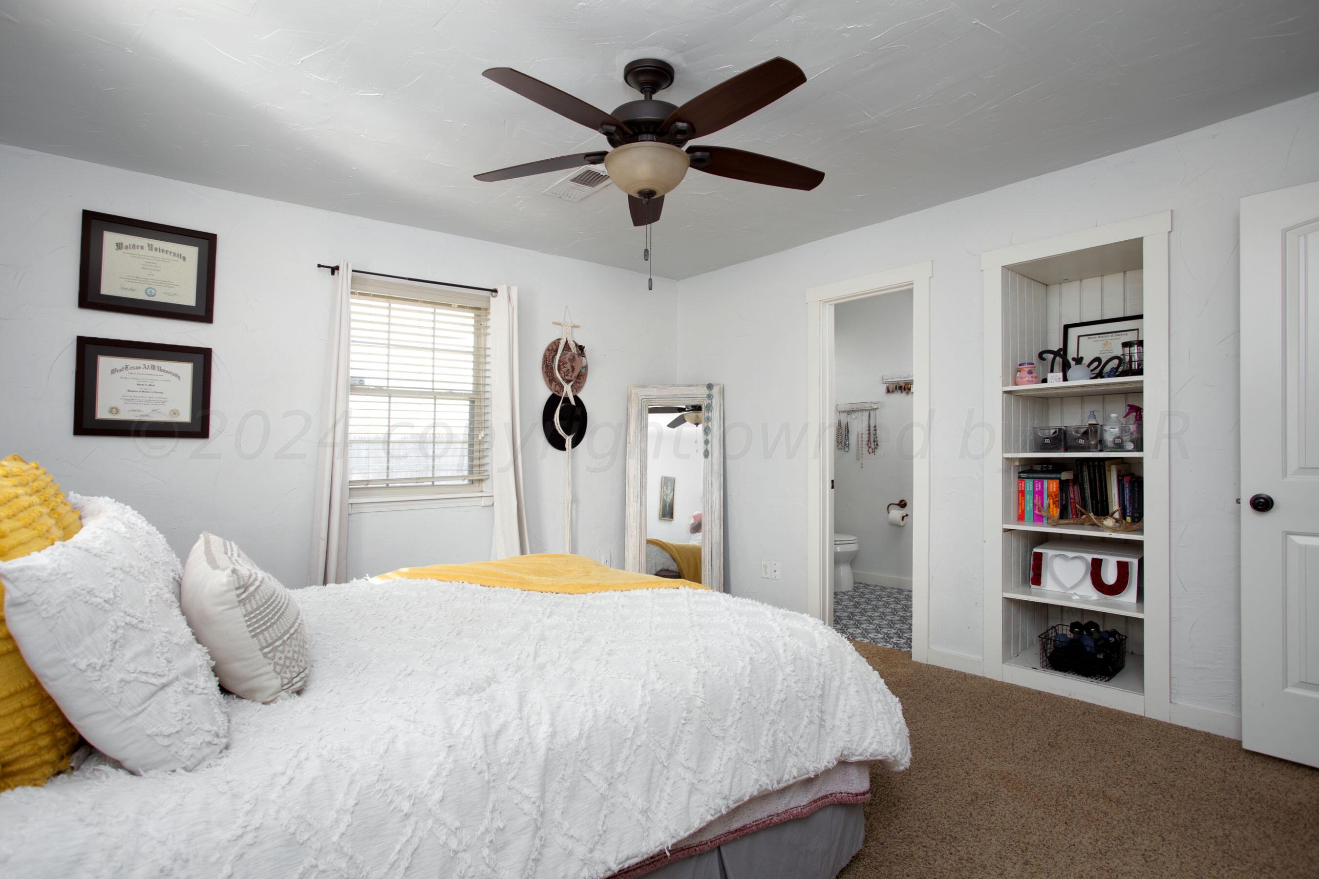 5109 Navajo Trail Amarillo, TX 79110 - Photo 22 of 29 a bedroom with a bed cabinets and window