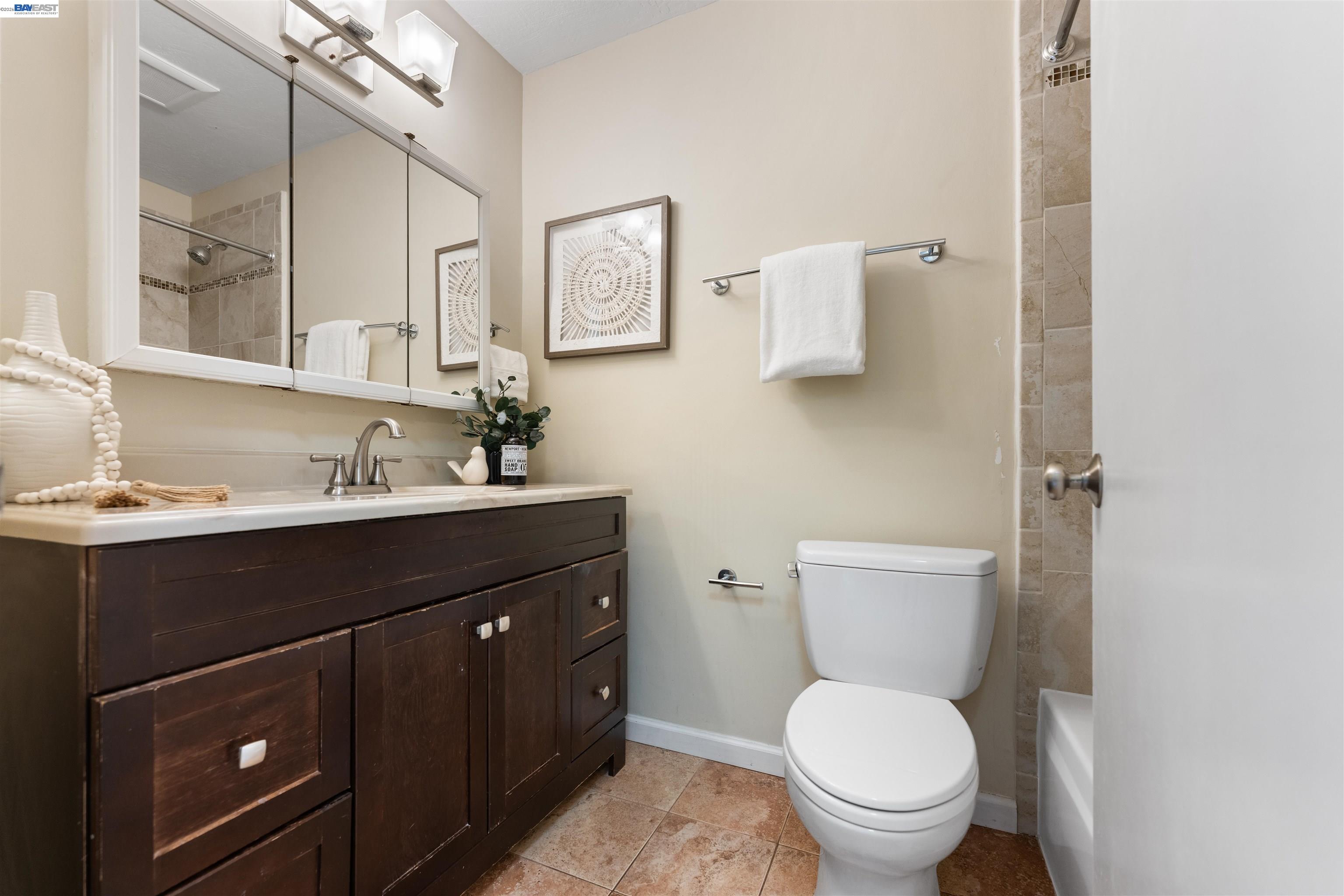 4081 Clayton Road, Unit 221 Concord, CA 94521 - Photo 17 of 23 a bathroom with a toilet sink and mirror
