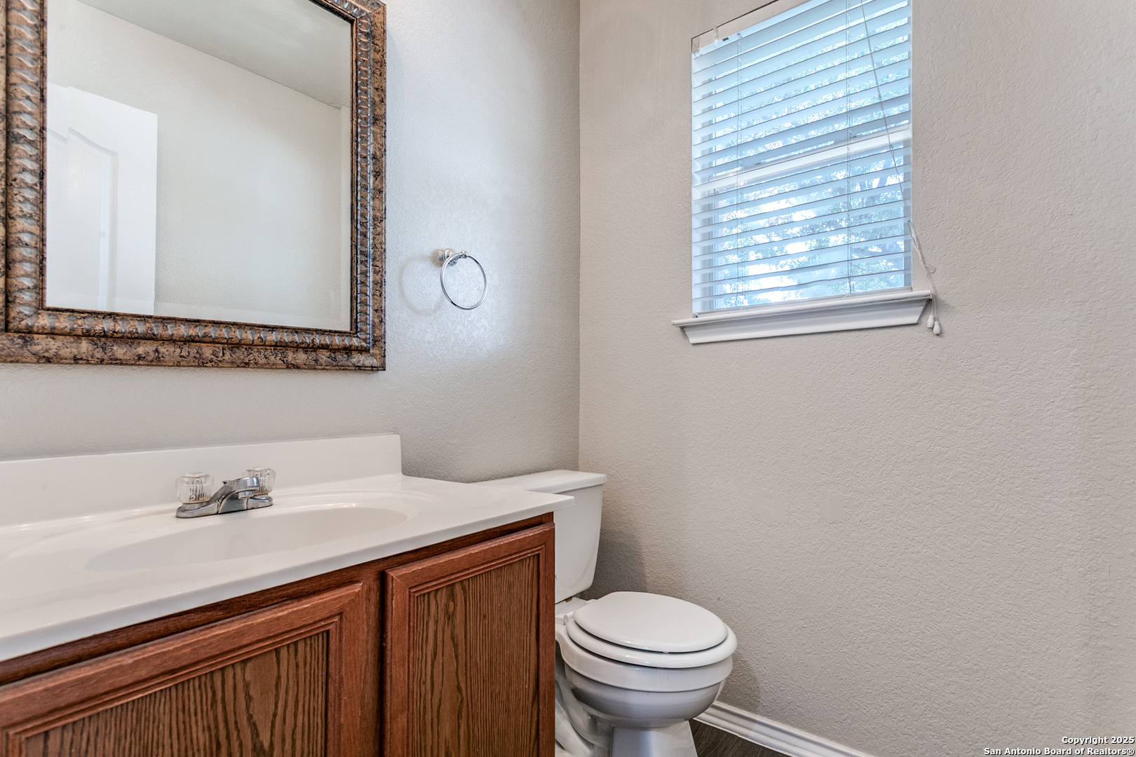 6609 Wood Bench Live Oak, TX 78233 - Photo 14 of 23 a bathroom with a sink mirror and toilet