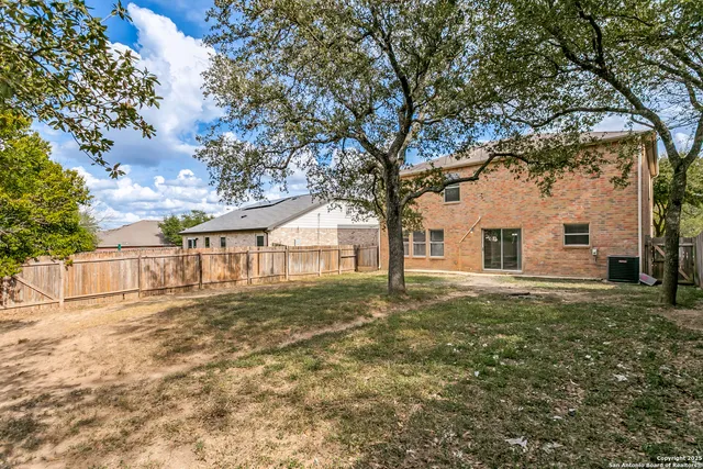 a big white house with a large tree in front of it