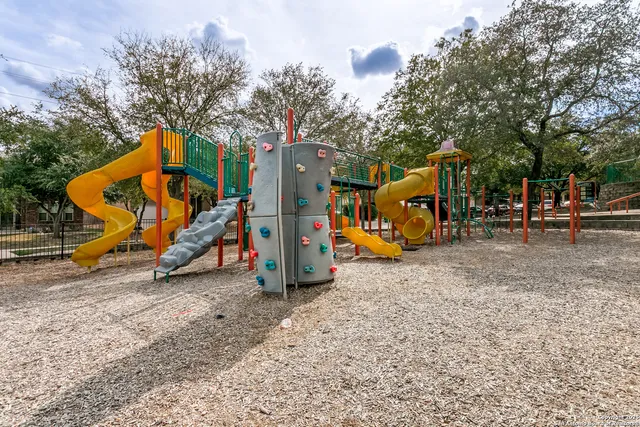 a view of outdoor space with playground and green space