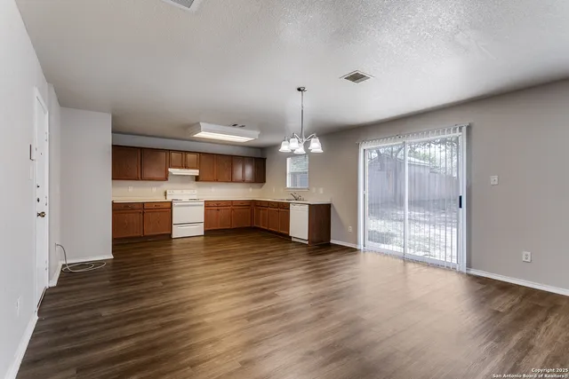 a view of a kitchen with a sink and microwave