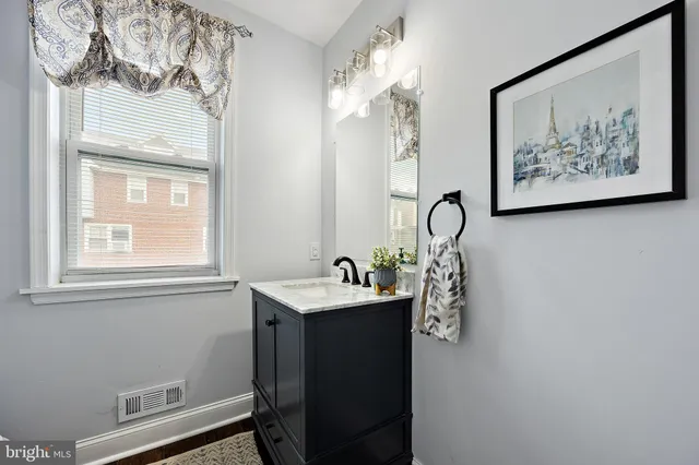 a view of a dining room with furniture a chandelier and wooden floor