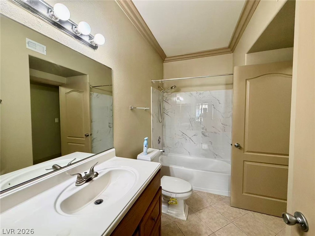 5525 West Flamingo Road, Unit 1019 Las Vegas, NV 89103 - Photo 13 of 18 A well-appointed bath features a combined tub and shower unit, complemented by a broad vanity.