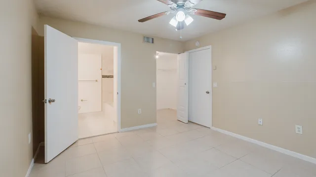 a bathroom with a granite countertop sink a mirror and a bathtub