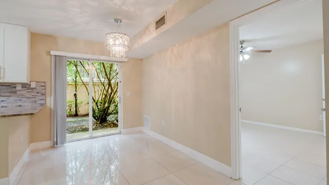 a view of an entryway with wooden floor and a chandelier