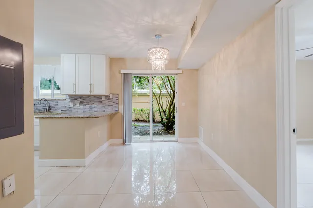 a view of a kitchen with granite countertop cabinets