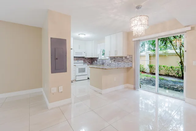 a view of a kitchen with furniture and chandelier