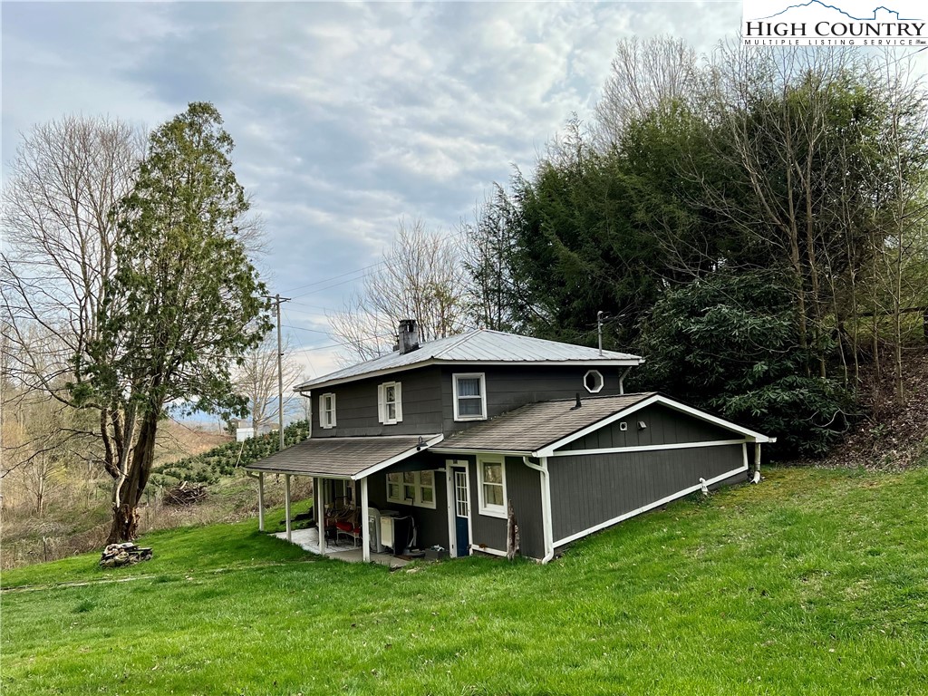 2601 Mountaindale Road Vilas, NC 28692 - Photo 2 of 14 a view of a house with a big yard and large trees
