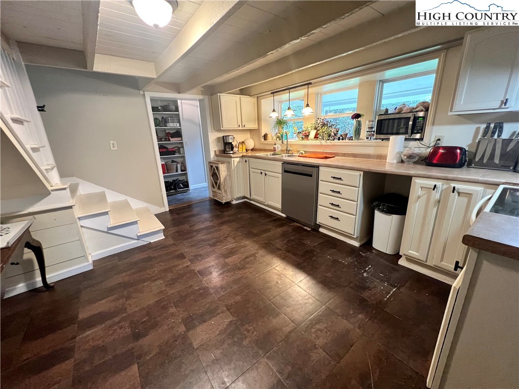 2601 Mountaindale Road Vilas, NC 28692 - Photo 6 of 14 a kitchen with stainless steel appliances a stove top oven a sink and a refrigerator