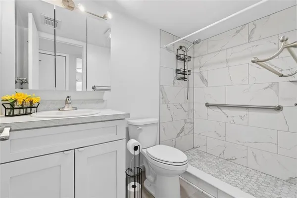 a view of a livingroom with a ceiling fan and window